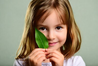 Girl holding green leaf