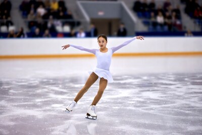 Girl figure skating on ice rink