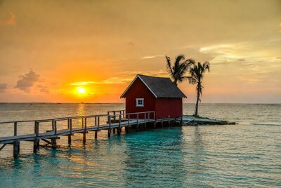 Red Cabin on Pier at Sunset