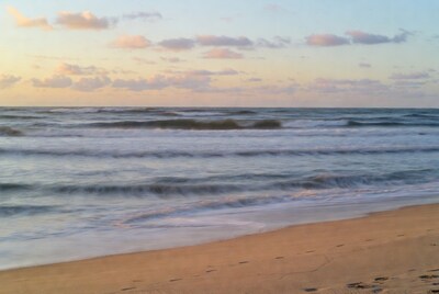 Ocean Waves Crashing on Beach at Sunset