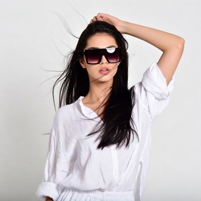 Asian woman in sunglasses with flowing hair