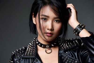 Asian woman in studded leather jacket