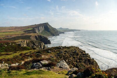 Cliff Edge Overlooking Ocean and Fields