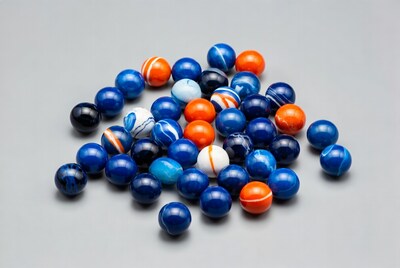 Colorful Marbles Pile on Gray Background