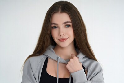 Young woman in gray hoodie smiling