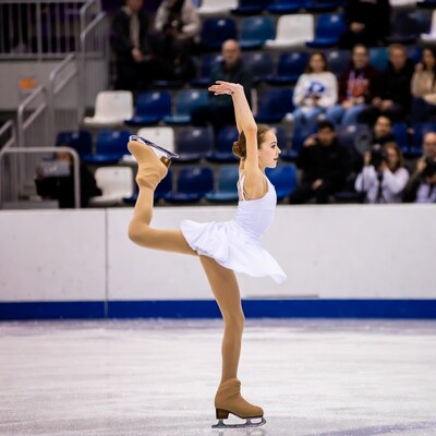 Girl figure skating on ice rink