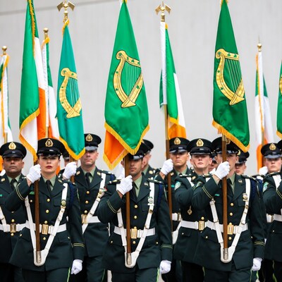 Irish Defense Forces marching with flags