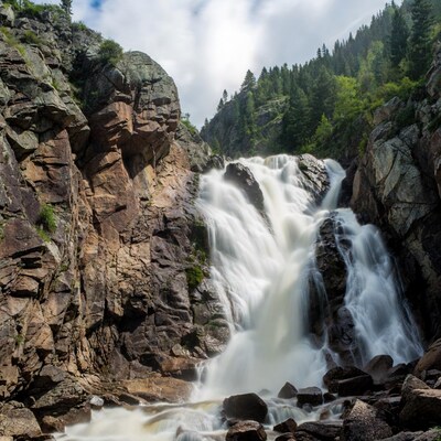 Waterfall cascading between rocky cliffs