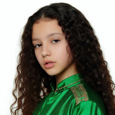 Girl in green qipao with curly hair