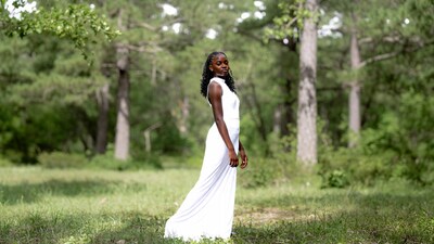 African woman in white dress in forest