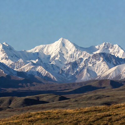 Snowy Mountains with Golden Hills