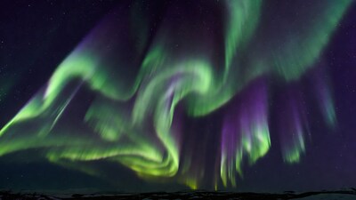 Vibrant Northern Lights over Snowy Landscape