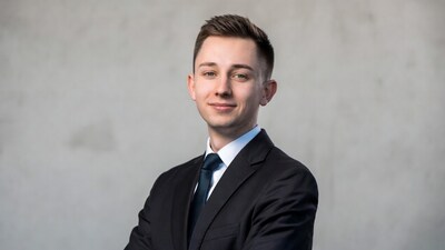 Young man in suit arms crossed