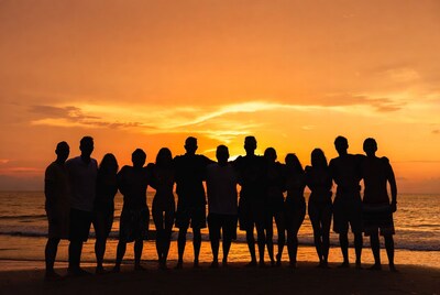 Group silhouettes at sunset beach