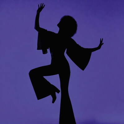 Silhouette of woman dancing in flared pants