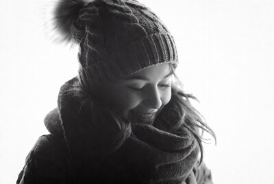 Woman smiling in knit beanie and scarf