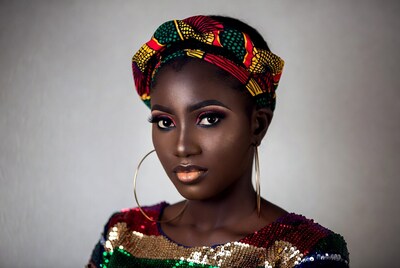 African woman in colorful headwrap and sequins