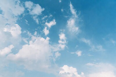 Fluffy white clouds in blue sky