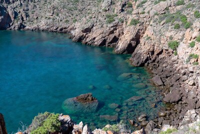 Turquoise bay surrounded by rocky cliffs
