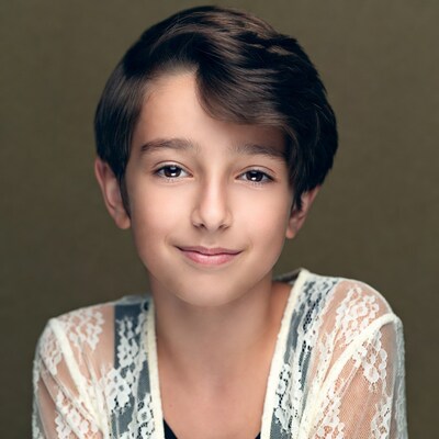 Boy with short brown hair smiling