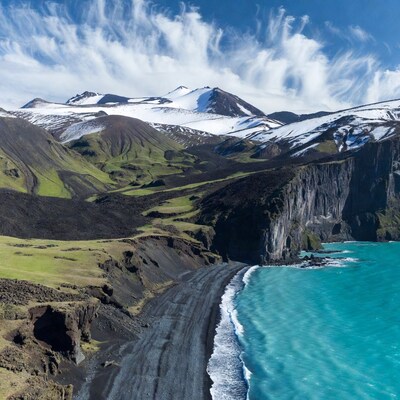 Black Sand Beach with Mountains and Turquoise Sea