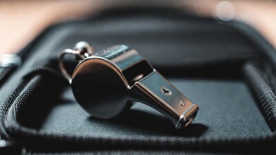 Silver whistle on black bag