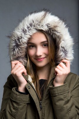 Teen girl smiling in fur hood jacket