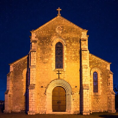 Stone Church at Night with Lit Windows