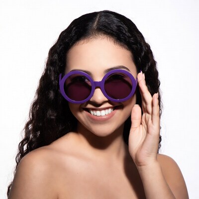 Woman smiling with purple sunglasses