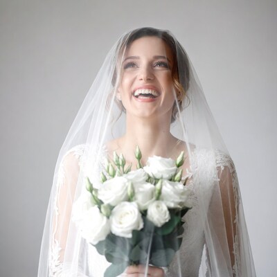Bride smiling with white roses