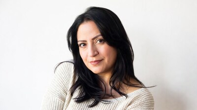 Smiling Latina woman in white sweater