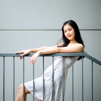 Asian woman leaning on railing