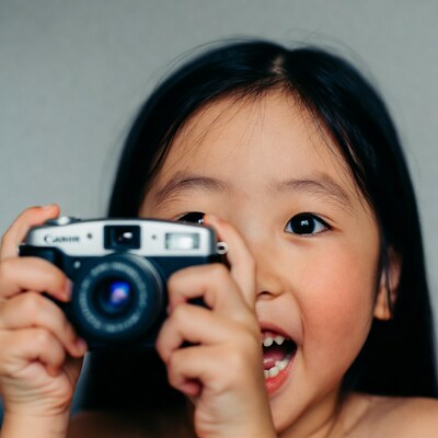 Asian girl holding Canon camera