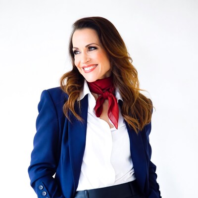 Smiling woman in blue blazer red scarf
