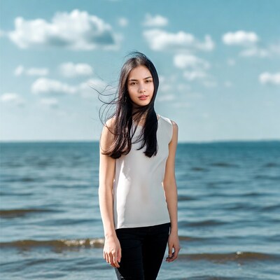 Asian woman standing by sea