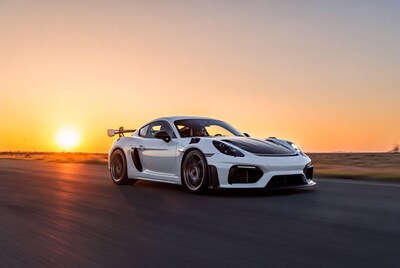 White Porsche 718 Cayman GT4 RS at sunset