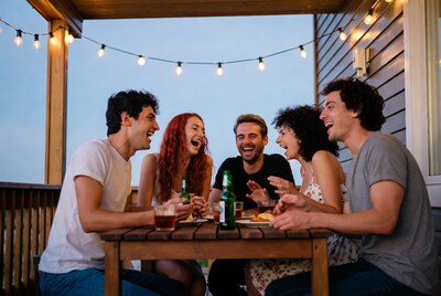 Friends laughing at deck table party
