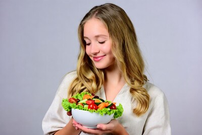 Girl holding fresh salad bowl