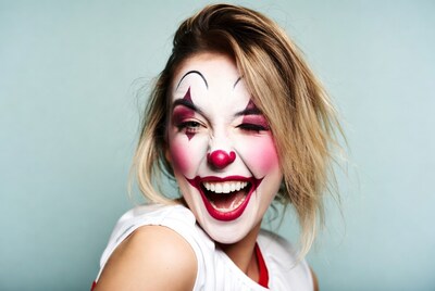 Woman in clown makeup laughing
