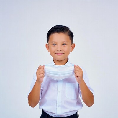 Asian boy holding face mask