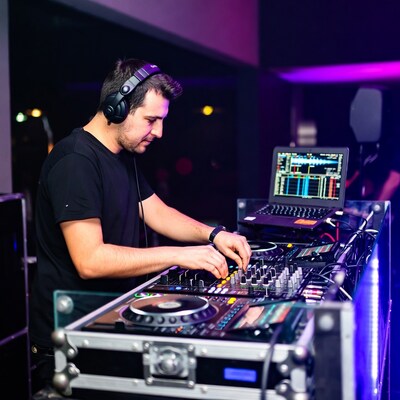 DJ man mixing music at club