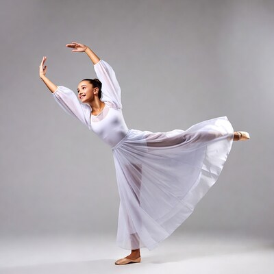 Young girl ballet dancer in white dress