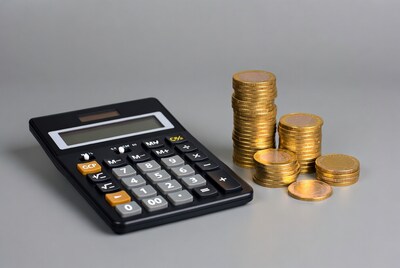 Calculator with gold coin stacks