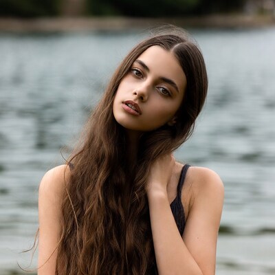 Woman with long hair by lake