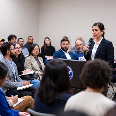 Woman speaking at podium with attentive audience