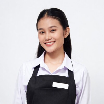 Asian woman in white shirt black apron