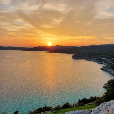 Sunset over coastal bay and mountains