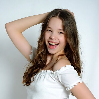 Girl laughing with hand in hair