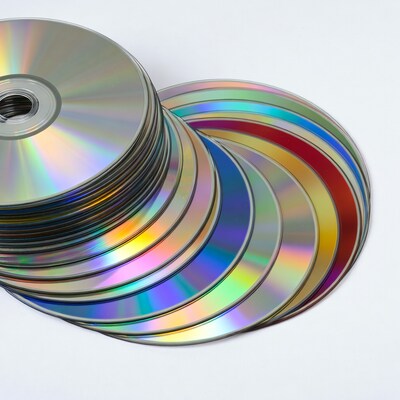 Stack of colorful CDs on white background