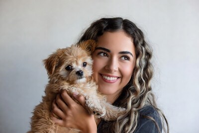 Woman holding fluffy puppy